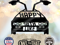 Black time machine car birthday cake topper with raised gull-wing doors, Happy lettering, personalized age 10th, and the name Luke.