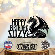 Black dragon birthday cake topper with a horned dragon, raised wing, curled tail, Happy Birthday lettering, and personalized name SUZY.