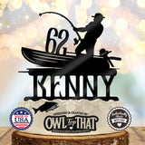 Black fishing birthday cake topper featuring an angler in a boat holding a bent fishing rod, personalized with the name Kenny and age 62.