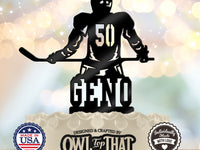 Black hockey birthday cake topper featuring a helmeted player holding a hockey stick, with number 50 on the jersey and the personalized name Geno below.
