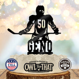 Black hockey birthday cake topper featuring a helmeted player holding a hockey stick, with number 50 on the jersey and the personalized name Geno below.