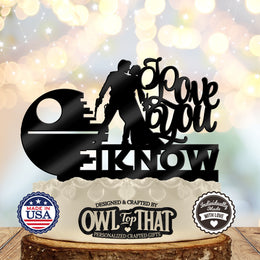 Black wedding cake topper featuring Han and Leia leaning toward a kiss, a partially constructed space station, and I Love You, I Know lettering.