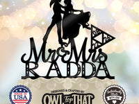 Black Link and Zelda wedding cake topper featuring a dancing couple, Mr & Mrs script, the surname Radda, and a date inside a triangular emblem.