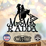 Black Link and Zelda wedding cake topper featuring a dancing couple, Mr & Mrs script, the surname Radda, and a date inside a triangular emblem.