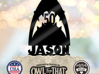 Black shark birthday cake topper with an open mouth, pointed teeth framing the personalized age 50, and the name Jason along the base.